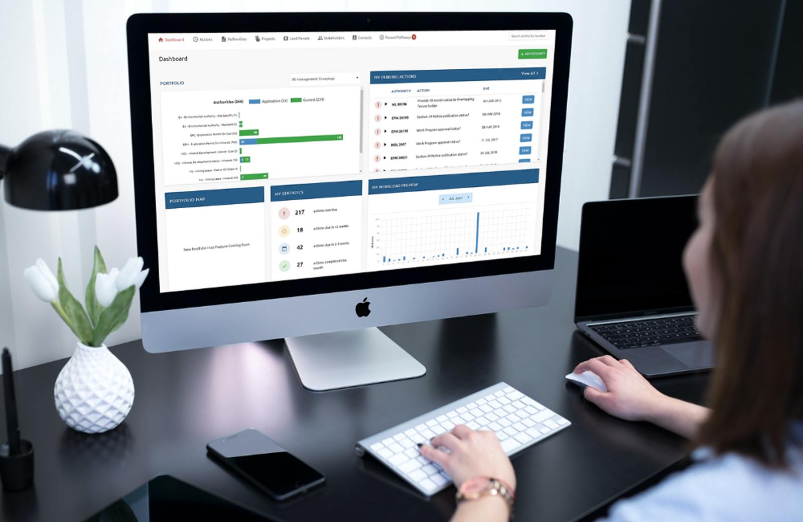A woman working on PX4 Software dashboard on Apple desktop