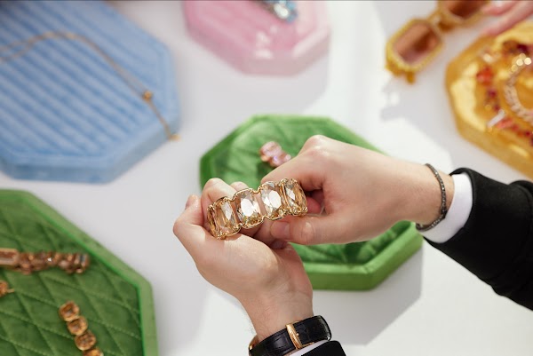 A hand holding a bracelet