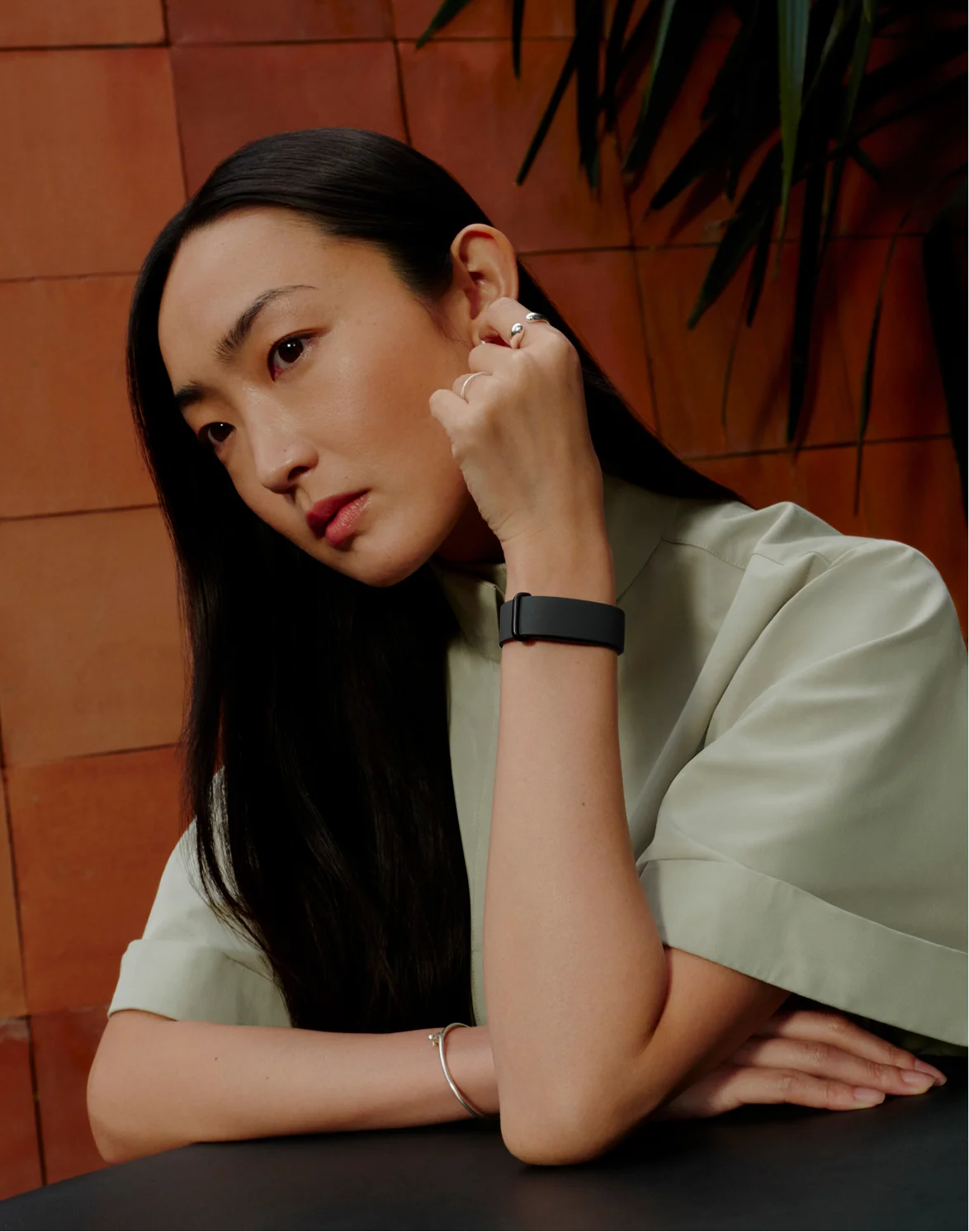 Image of woman wearing Google Fitbit Air. 