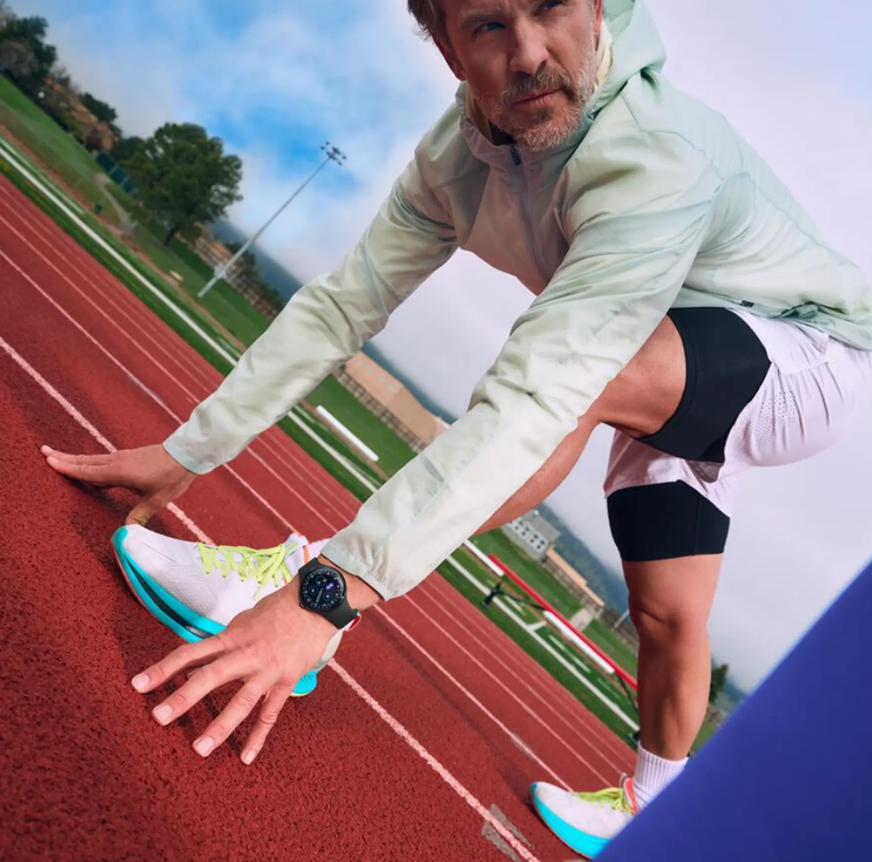 Image of man stretching wearing Google Fitbit Air