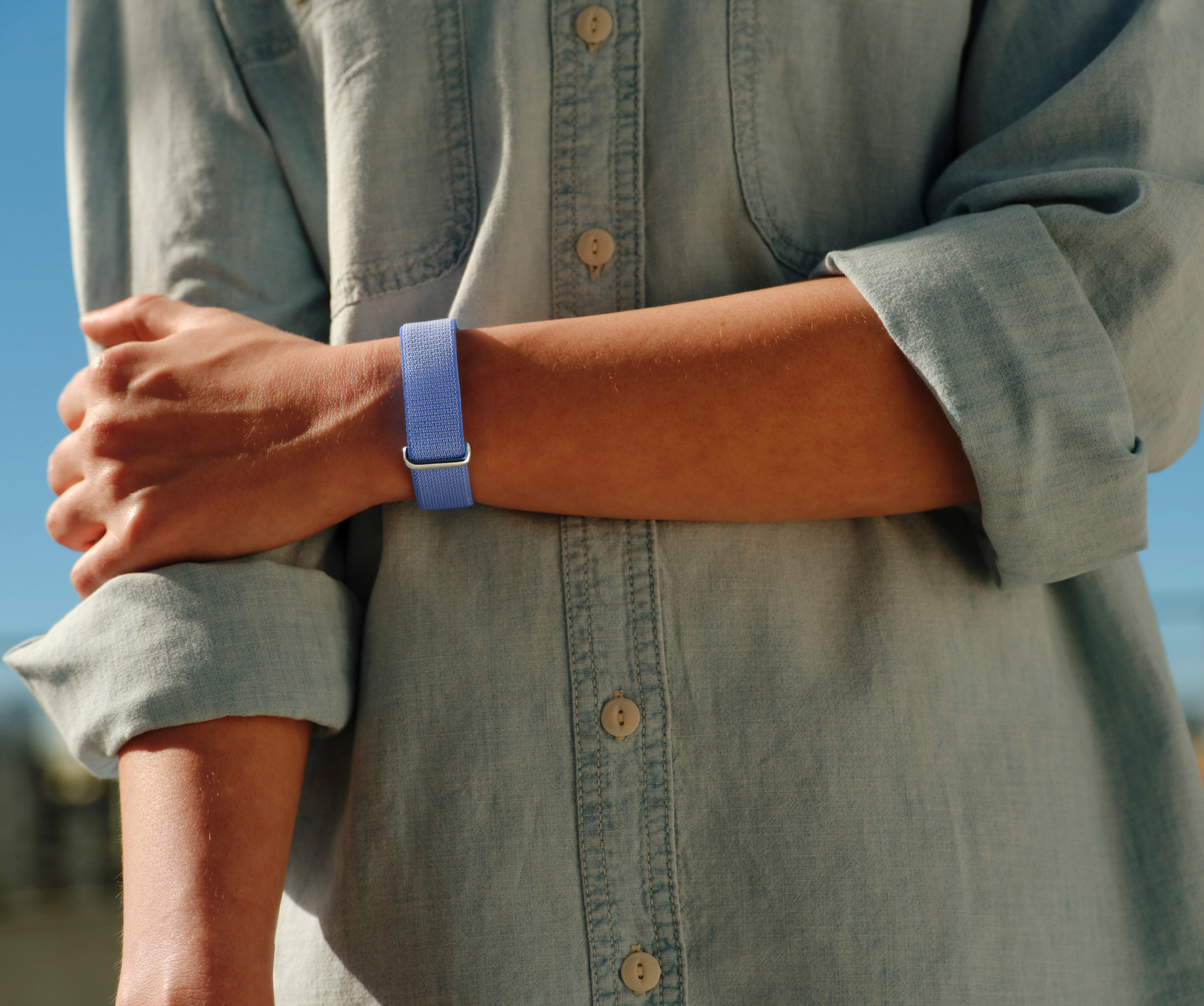 Image of woman wearing Google Fitbit Air.