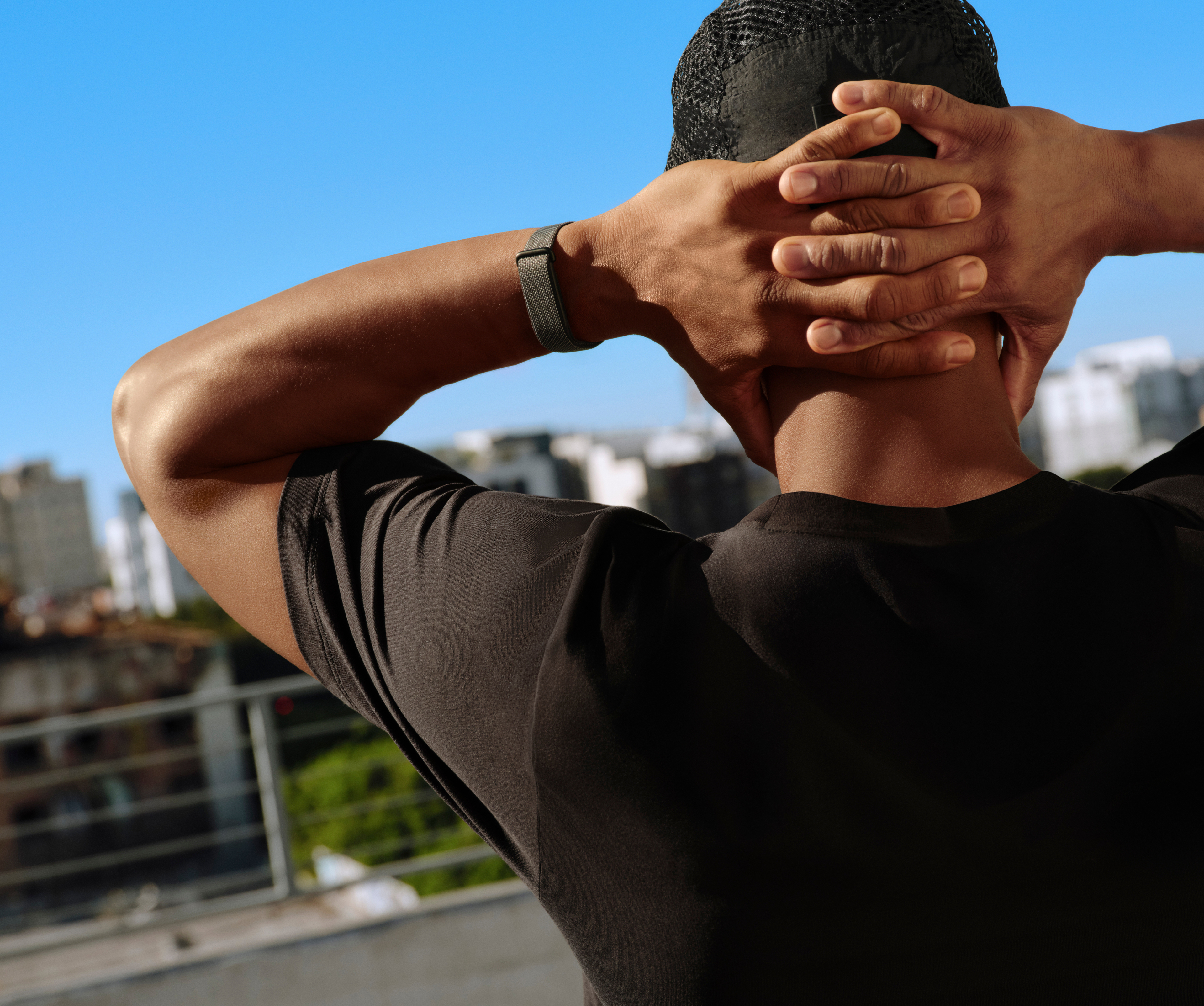 Image of man recovering after a workout wearing Google Fitbit Air.