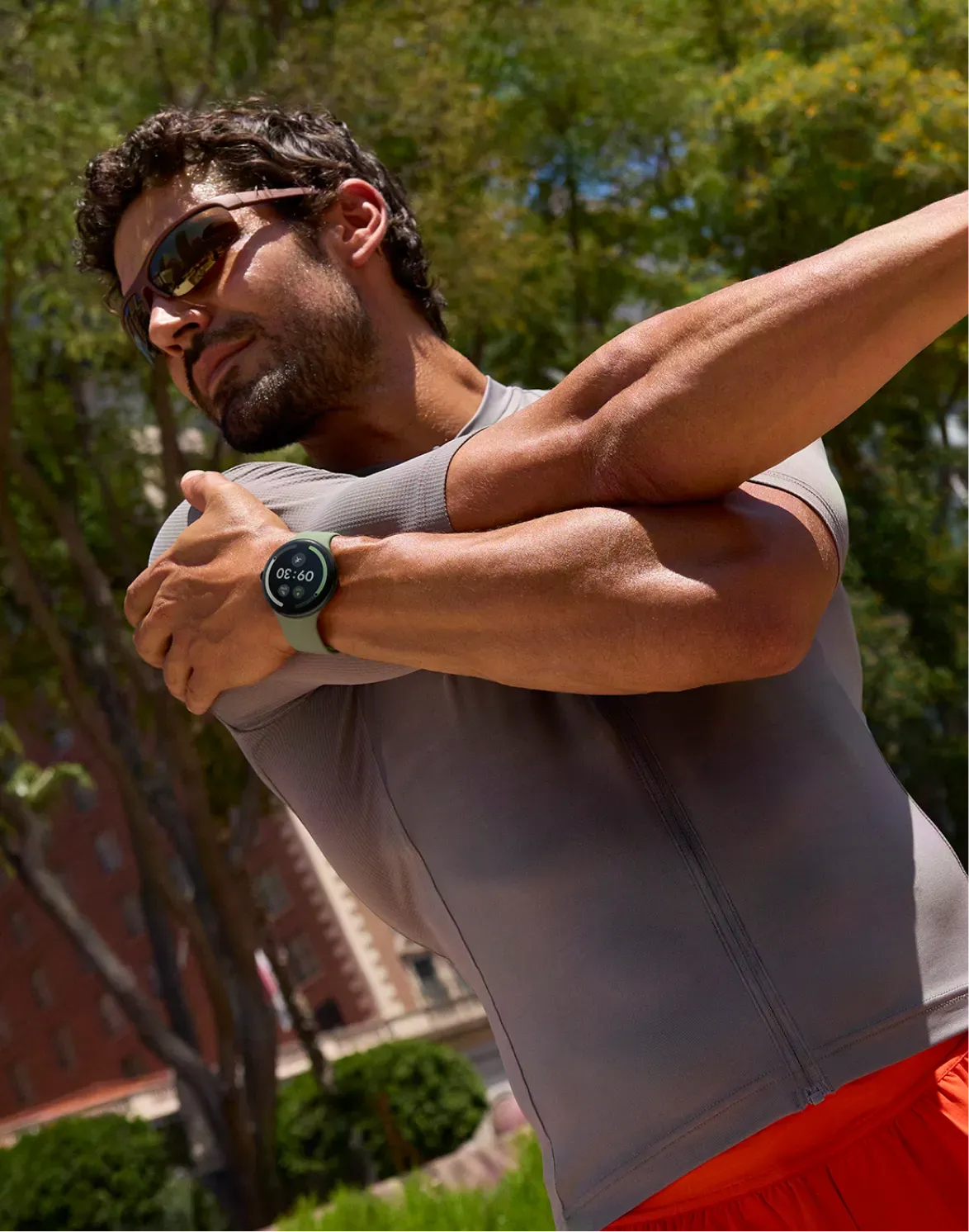 Image of man stretching wearing Pixel Watch 5. 