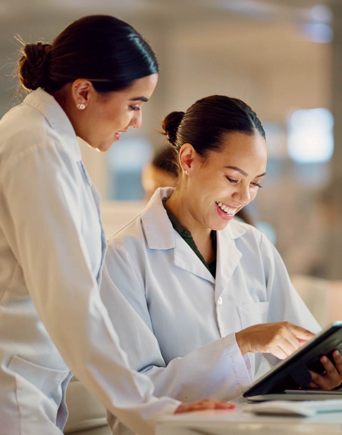 Image of two women reviewing research in a lab