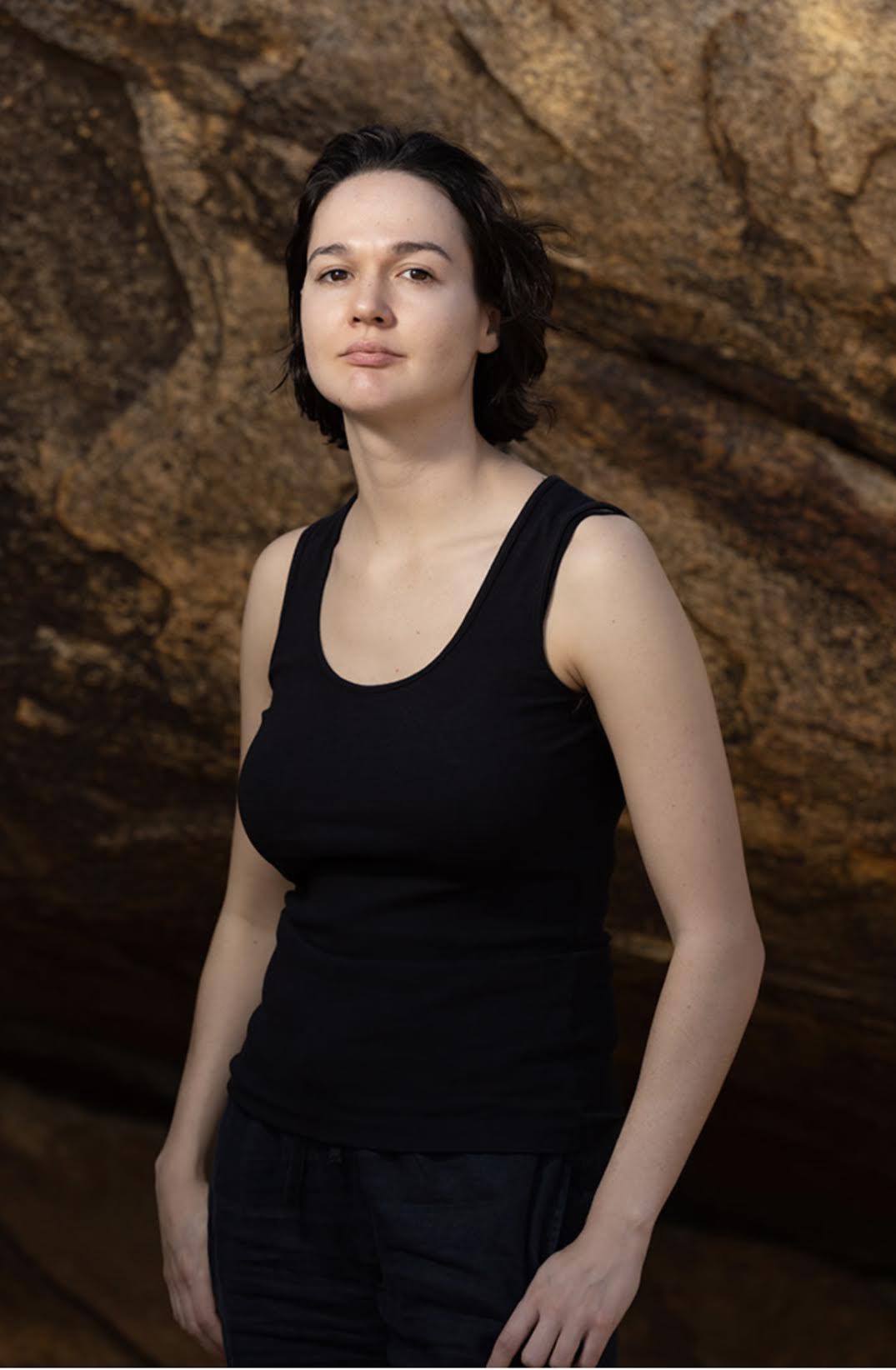 A photograph of an Indigenous Australian woman with short dark hair