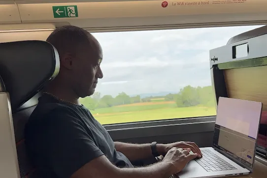 Shawn Mottley works on Classic Games Network while traveling by train in France.