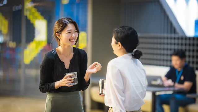 A lady with a glass of water.