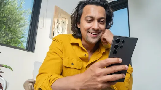 Image of a man using his Android-powered device