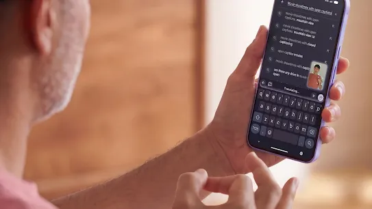 A person signs with one hand while holding a smartphone, demonstrating the Gboard sign-to-text dictation feature.