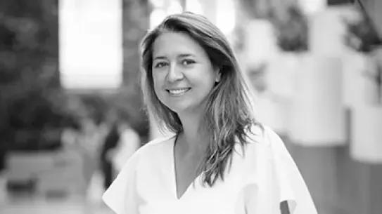Founder Kasia Dorsey stands along a railing outdoors.