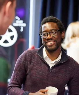 A man with a cup in hand.