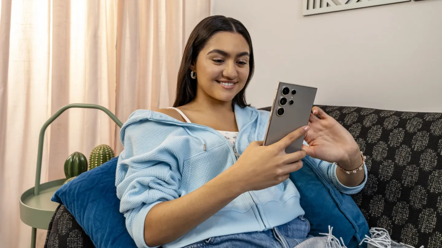 Woman holding her Android smartphone.