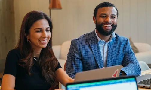 A man and woman smiling