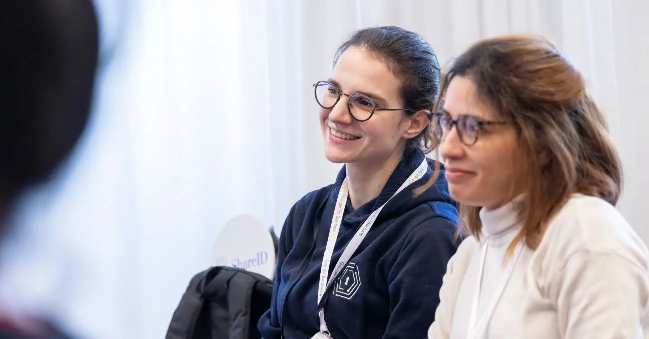 Two women looking at something.