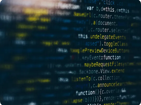 A close-up, stylized view of colorful computer code on a dark screen with a shallow depth-of-field effect.