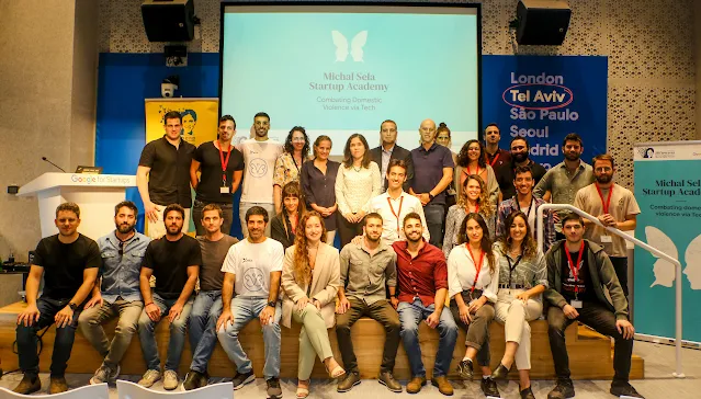People standing & seating on stage for group photo