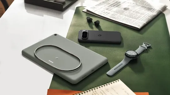 Android phone, tablet, watch and earbuds placed together on a table.