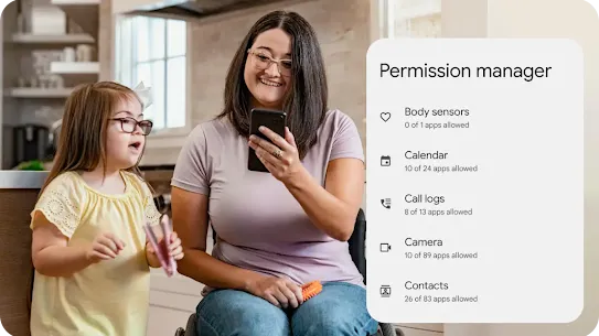 A parent in a wheelchair smiles looking at an Android phone while their child sings and dances. A graphic overlay highlights the details of permission manager including the number of apps allowed access to body sensors, calendar, call logs, camera and contacts.