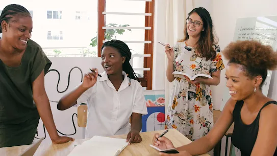 A photograph of young job-seekers participating in a collaborative learning session, used to illustrate the Harambee Youth Employment Accelerator case study. The image reflects Harambee's mission in South Africa to "pull together" and dismantle barriers to entry-level work, highlighting how the nonprofit uses Google Cloud and AI to match millions of young people with sustainable earning and skilling opportunities.