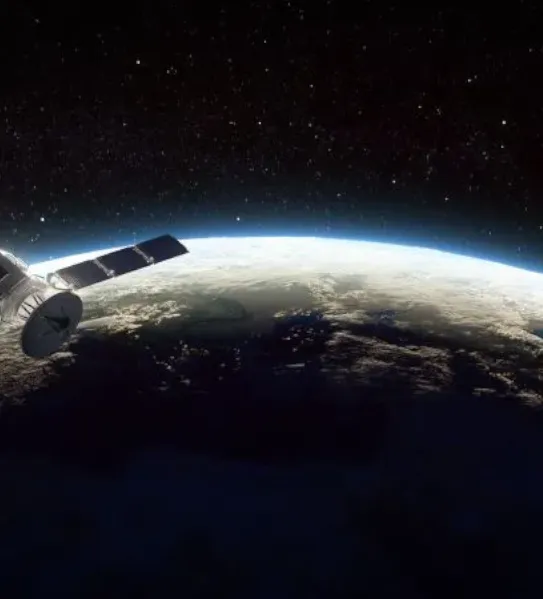A high-resolution 3D render of a satellite with extended solar panels orbiting Earth, with the sun's light creating a bright curve along the planet's horizon against a starry black space background.