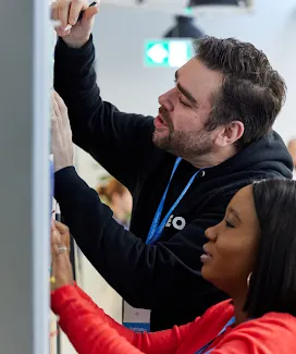 A man and woman writing something on board