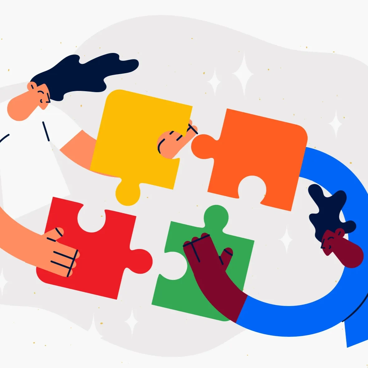 Two people connecting four colored puzzle pieces into a square.