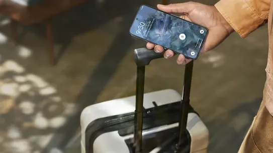 Travelling man holding his Android phone