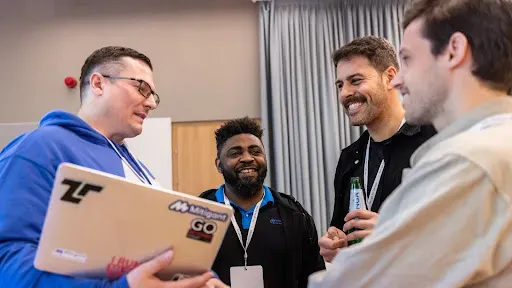 Nils Karn Mitigant CEO + co-founder beside Kennedy Torkura, CTO + co-founder laughing with two Google team members at the Google for Startups Growth Academy: AI for Cybersecurity kick-off event  in Warsaw