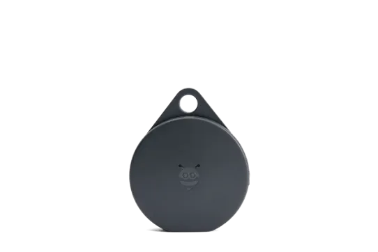A circular, black Tracking Tag device.