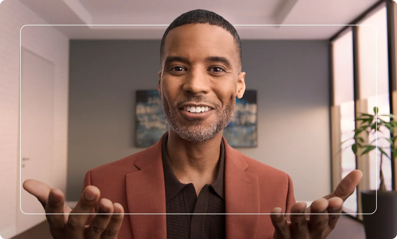 A smiling person gestures with open hands extending beyond a thin rectangular frame, illustrating a 3D effect.