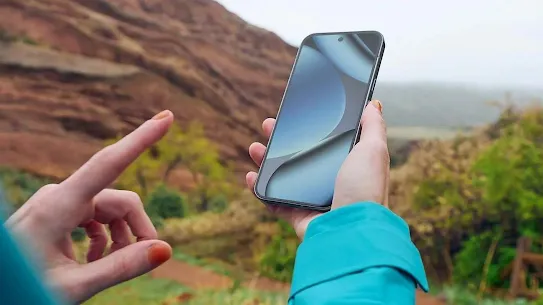 A woman using an Android phone in the wilderness.