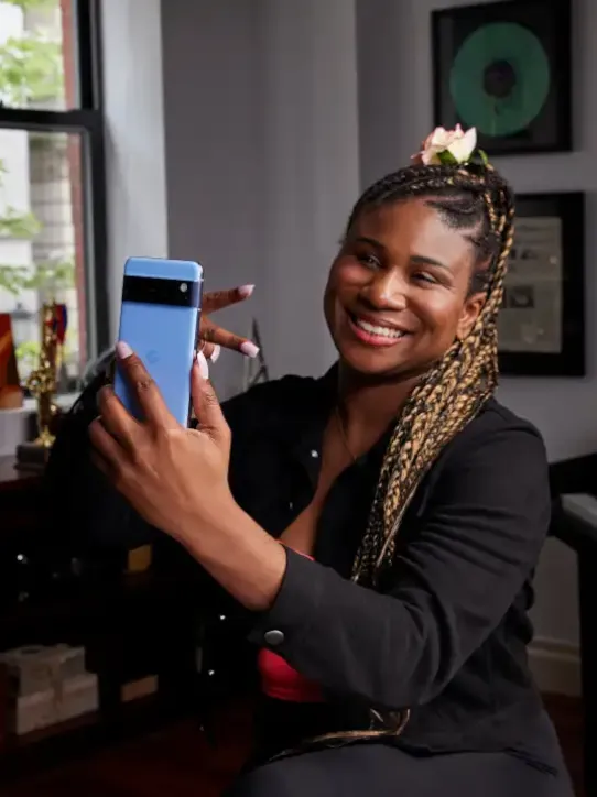 Woman taking selfie with Android phone.