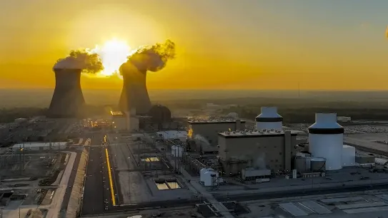 Nuclear power plant with sunrise in the background