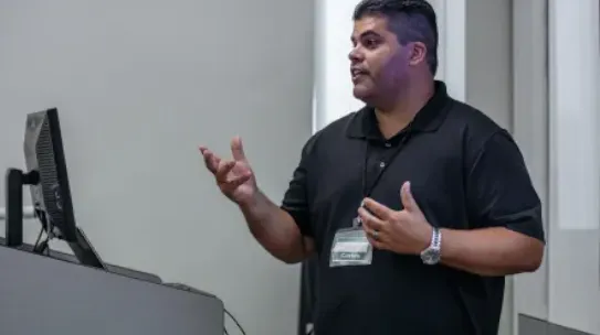 A teacher stands in front of the class.