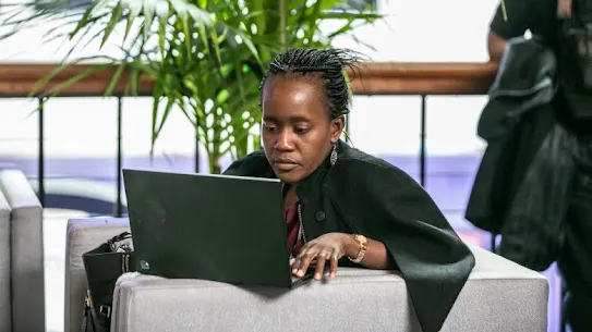 A woman is working on laptop.