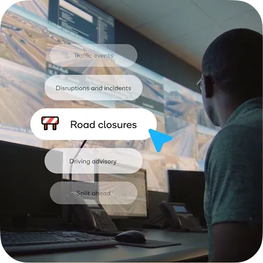 Traffic control operator monitoring live city traffic screens and Waze road closures data