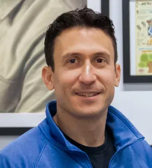 A headshot of Jeffrey Braverman, CEO of Nuts.com, smiling and wearing a blue quarter-zip fleece, featured in a New Jersey case study about optimizing snack brand operations with AI.