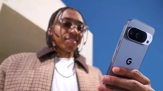 Man holding his Android phone outside and looking at the screen.