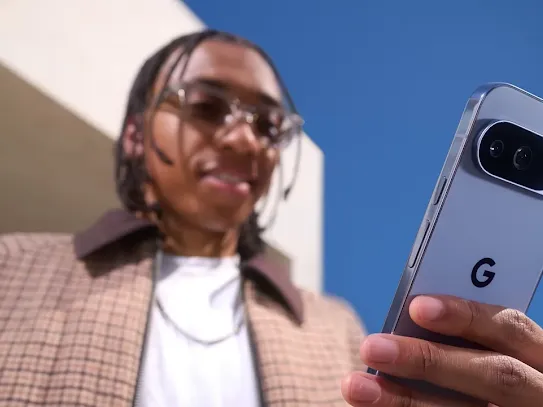 Man holding his Android phone outside and looking at the screen.