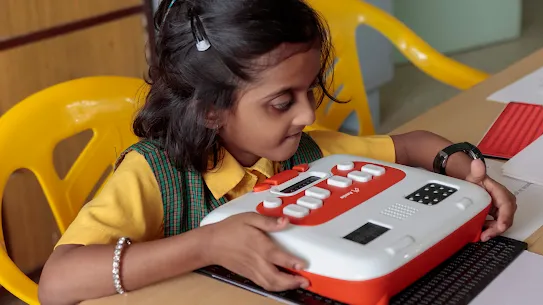 Young girl student learns Braille on Annie, an edtech device from Thinkerbell Labs