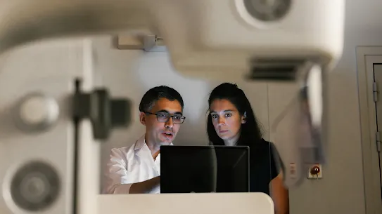 Two people looking at a screen