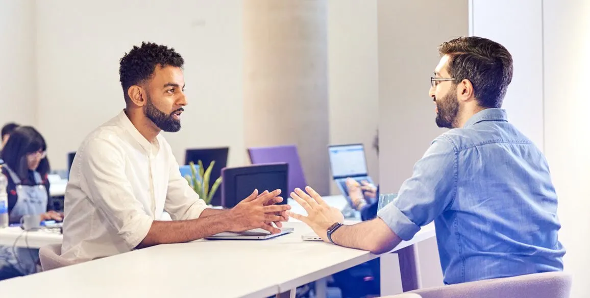 Ismail Jeilani, CEO and founder of LiveLink discussing with a man