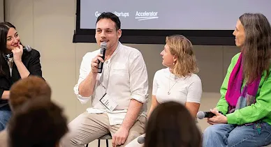 A group of people is engaged in a deep discussion, with microphones in their hands.