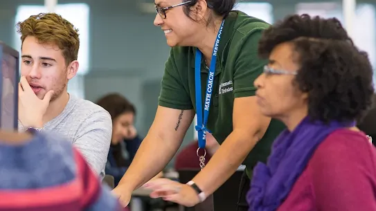 Three people in a classroom setting