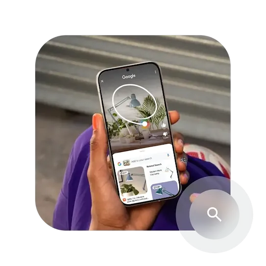 A hand holding a phone with the screen showing an abstract example of how the Circle to Search feature works.