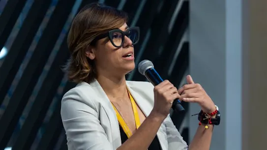 A woman is addressing on mic