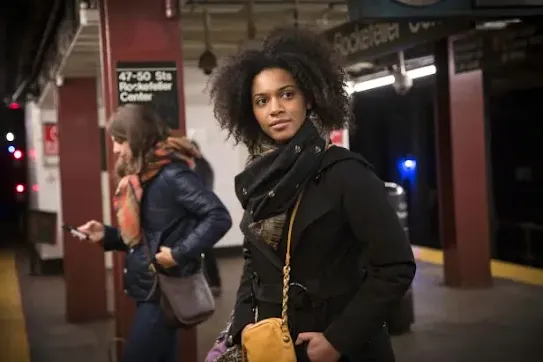 two women wait at Rockefeller Center metro stop for their next subway train