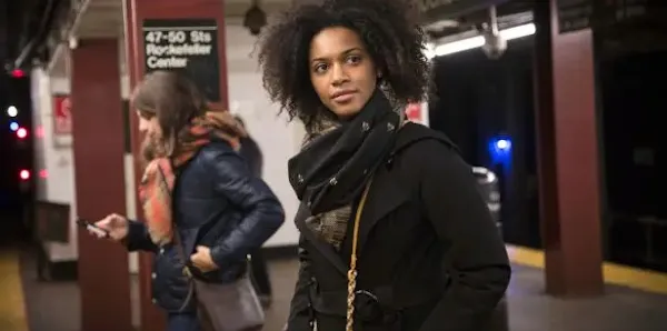 two women wait at Rockefeller Center metro stop for their next subway train