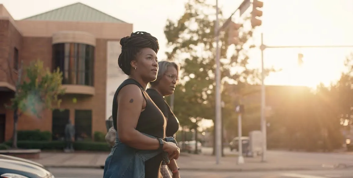 The founders, Ashlee Ammons and Kerry Schrader, walk along a street at sunset.