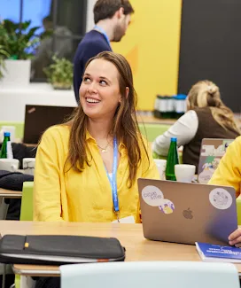 A woman wearing yellow top and looking at something